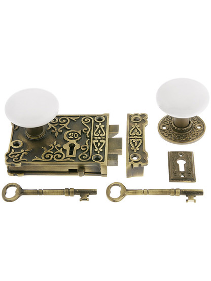 Solid Brass Century Rim Lock Set with White Porcelain Knobs.